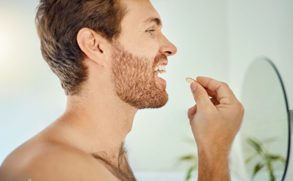 person holding white medication pill